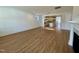 Open living area featuring a fireplace, wood flooring, and a view to the modern kitchen at 316 Catheys Creek Cir, Wendell, NC 27591