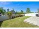 Manicured backyard with lush lawn, privacy fence, mature trees, and stone patio area at 317 City Center Ln, Wendell, NC 27591