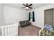 Bright bedroom featuring carpeted floors, a cozy daybed, and a crib at 317 City Center Ln, Wendell, NC 27591