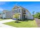 Charming two-story home features a well-manicured lawn and a two-car garage at 317 City Center Ln, Wendell, NC 27591