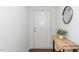 Bright entryway with hardwood floors, rustic table and neutral paint at 317 City Center Ln, Wendell, NC 27591