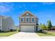 Charming home with a two-car garage, manicured lawn and beautiful curb appeal at 317 City Center Ln, Wendell, NC 27591