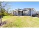 Inviting backyard features a screened-in porch, green lawn, and a secure fence, ideal for relaxation and outdoor activities at 330 Middleton Pl, Chapel Hill, NC 27516