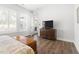 Bright bedroom with wood floors, dresser and doorway leading to outdoor balcony area at 330 Middleton Pl, Chapel Hill, NC 27516