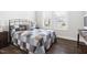Bedroom featuring neutral decor and an iron bed frame, plus wood flooring at 330 Middleton Pl, Chapel Hill, NC 27516