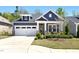 Charming blue two-story home with white trim, a manicured lawn, and an attached two-car garage at 330 Middleton Pl, Chapel Hill, NC 27516
