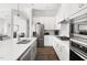 Well-equipped kitchen featuring stainless appliances, white cabinets, a large island, and sleek countertops at 330 Middleton Pl, Chapel Hill, NC 27516