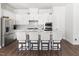 Bright, modern kitchen featuring white cabinets, stainless steel appliances, and an island with barstool seating at 330 Middleton Pl, Chapel Hill, NC 27516