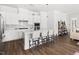 Open kitchen with white cabinets, stainless steel appliances, a center island and bar stool seating at 330 Middleton Pl, Chapel Hill, NC 27516