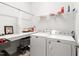 Laundry room featuring front-load washer and dryer with folding table and shelving at 330 Middleton Pl, Chapel Hill, NC 27516