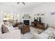 Bright living room with fireplace, large windows, and hardwood floors at 330 Middleton Pl, Chapel Hill, NC 27516