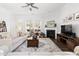 Bright living room with fireplace, large windows, and hardwood floors at 330 Middleton Pl, Chapel Hill, NC 27516