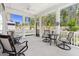 Screened-in patio features ceiling fan and multiple seating areas with views of yard at 330 Middleton Pl, Chapel Hill, NC 27516