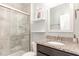 Bathroom with a glass shower door, granite countertops and bright vanity mirror at 3360 Bordwell Ridge Dr, New Hill, NC 27562