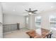 Upstairs loft with carpet, modern ceiling fan, neutral colors, and natural light with a dedicated workspace at 3360 Bordwell Ridge Dr, New Hill, NC 27562