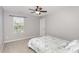 Bedroom features a window with backyard view, ceiling fan and a bed with patterned comforter at 3360 Bordwell Ridge Dr, New Hill, NC 27562