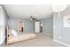 Bedroom features a bed with under-bed storage, neutral gray walls, and a stylish light fixture at 3360 Bordwell Ridge Dr, New Hill, NC 27562