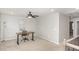 Well-lit bedroom/office space with carpet, modern ceiling fan, neutral colors, and dedicated desk area at 3360 Bordwell Ridge Dr, New Hill, NC 27562