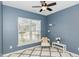 Cozy bedroom featuring a ceiling fan, plush rug and a large window offering plenty of natural light at 3360 Bordwell Ridge Dr, New Hill, NC 27562