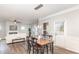 Dining area featuring a wooden table with seating for four, and a view of the living room at 3360 Bordwell Ridge Dr, New Hill, NC 27562