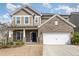 Charming two-story home with a brick and siding exterior, featuring a two-car garage and well-maintained landscaping at 3360 Bordwell Ridge Dr, New Hill, NC 27562