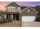 Charming two-story home with a brick and siding exterior, featuring a two-car garage and well-maintained landscaping at 3360 Bordwell Ridge Dr, New Hill, NC 27562