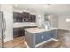 Modern kitchen with stainless steel appliances, granite countertops, and a center island with a sink at 3360 Bordwell Ridge Dr, New Hill, NC 27562