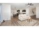 Spacious open-concept living area with modern decor, hardwood floors, and a view of the kitchen and dining at 3360 Bordwell Ridge Dr, New Hill, NC 27562