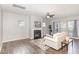 Cozy living room with fireplace, hardwood floors, and large windows that provide natural light at 3360 Bordwell Ridge Dr, New Hill, NC 27562