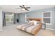 Spacious main bedroom with a ceiling fan, neutral decor, and a large window overlooking the outdoors at 3360 Bordwell Ridge Dr, New Hill, NC 27562