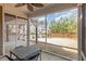 Covered screened porch overlooking a spacious backyard providing an outdoor space for relaxation and entertaining at 3360 Bordwell Ridge Dr, New Hill, NC 27562