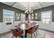 Elegant dining room with coffered ceilings, wainscoting, and modern chandelier at 34 Tea Olive Ct, Clayton, NC 27520