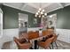 Elegant dining area features a wooden table, designer lighting, and stylish decor, perfect for hosting gatherings at 34 Tea Olive Ct, Clayton, NC 27520