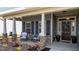 Inviting front porch with stone accents and seating, perfect for relaxing outdoors at 34 Tea Olive Ct, Clayton, NC 27520