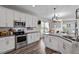Modern kitchen features white cabinets, stainless steel appliances, and a center island at 34 Tea Olive Ct, Clayton, NC 27520