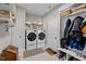 Well-organized laundry room featuring a side-by-side washer and dryer, ample storage, and stylish decor at 34 Tea Olive Ct, Clayton, NC 27520