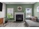 Cozy living room with a fireplace, lots of light, and modern decor at 34 Tea Olive Ct, Clayton, NC 27520