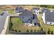 Aerial view of a spacious backyard with a patio, fire pit, and lush landscaping. The perfect outdoor space! at 34 Tea Olive Ct, Clayton, NC 27520