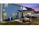 Private backyard featuring a stone patio with fire pit, outdoor seating, a grill, and manicured lawn at 34 Tea Olive Ct, Clayton, NC 27520