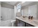 Bright bathroom featuring a shower-tub combo and a double sink vanity with modern fixtures at 34 Tea Olive Ct, Clayton, NC 27520