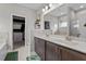 Bright bathroom featuring a double sink vanity, a large mirror, and an accessible walk-in closet at 34 Tea Olive Ct, Clayton, NC 27520
