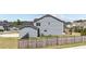 Side view of a blue two-story home with a fenced yard and well-maintained landscaping at 34 Tea Olive Ct, Clayton, NC 27520