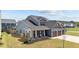 Attractive exterior view of a home with a welcoming front porch, three-car garage, and well-maintained lawn at 34 Tea Olive Ct, Clayton, NC 27520