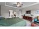 Well-lit main bedroom with tray ceilings, a ceiling fan, and an ensuite bathroom with double vanities at 34 Tea Olive Ct, Clayton, NC 27520