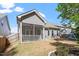 Lush backyard featuring a screened porch and a swing set, perfect for relaxation and play at 356 Avery Glenn Way, Fuquay Varina, NC 27526