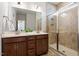 Modern bathroom with a double vanity, walk-in shower, and neutral tile at 356 Avery Glenn Way, Fuquay Varina, NC 27526
