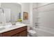 Well-lit bathroom showcasing a vanity with modern fixtures and a shower-tub combination at 356 Avery Glenn Way, Fuquay Varina, NC 27526