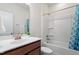 Bright bathroom with vanity, sink, mirror, shower and blue patterned curtain at 356 Avery Glenn Way, Fuquay Varina, NC 27526