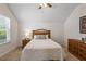 Bright bedroom with a queen bed, ceiling fan, and natural light from a window at 356 Avery Glenn Way, Fuquay Varina, NC 27526