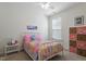 Cozy bedroom with a metal frame bed, colorful quilt, and matching storage at 356 Avery Glenn Way, Fuquay Varina, NC 27526